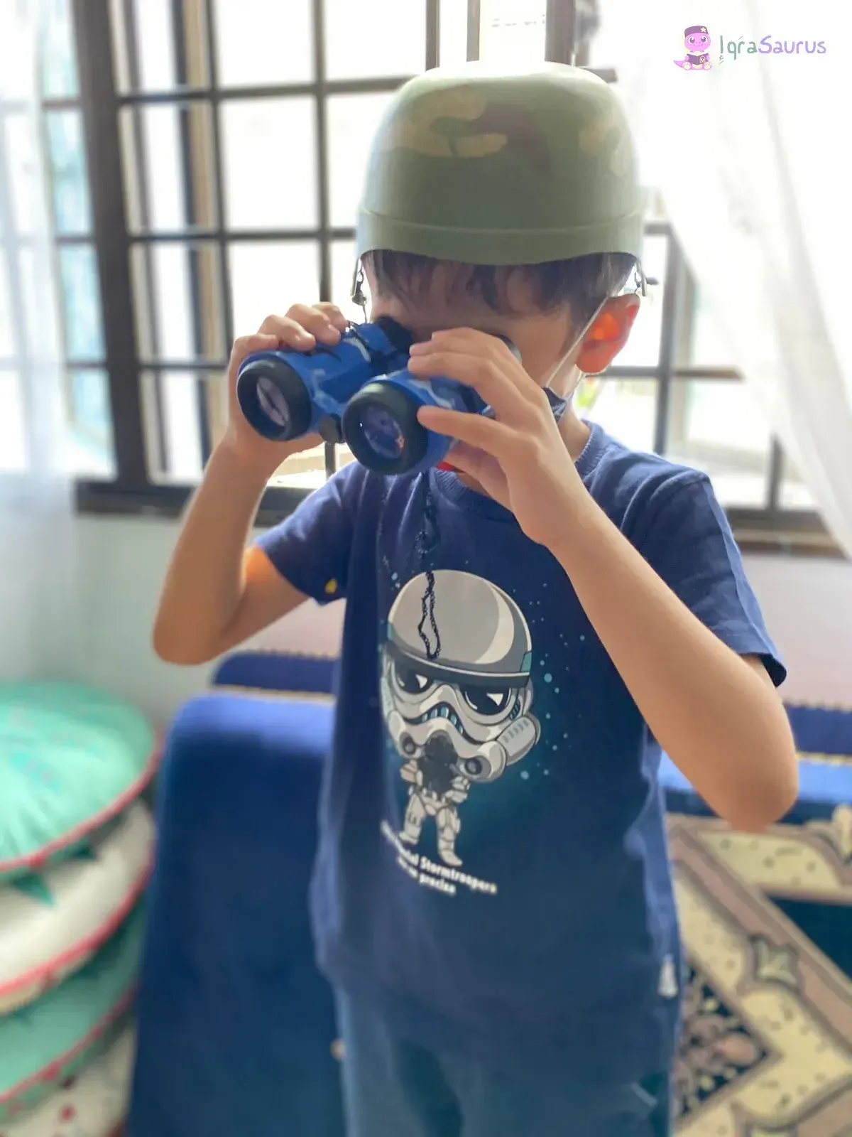A boy in a helmet looking through a pair of binoculars