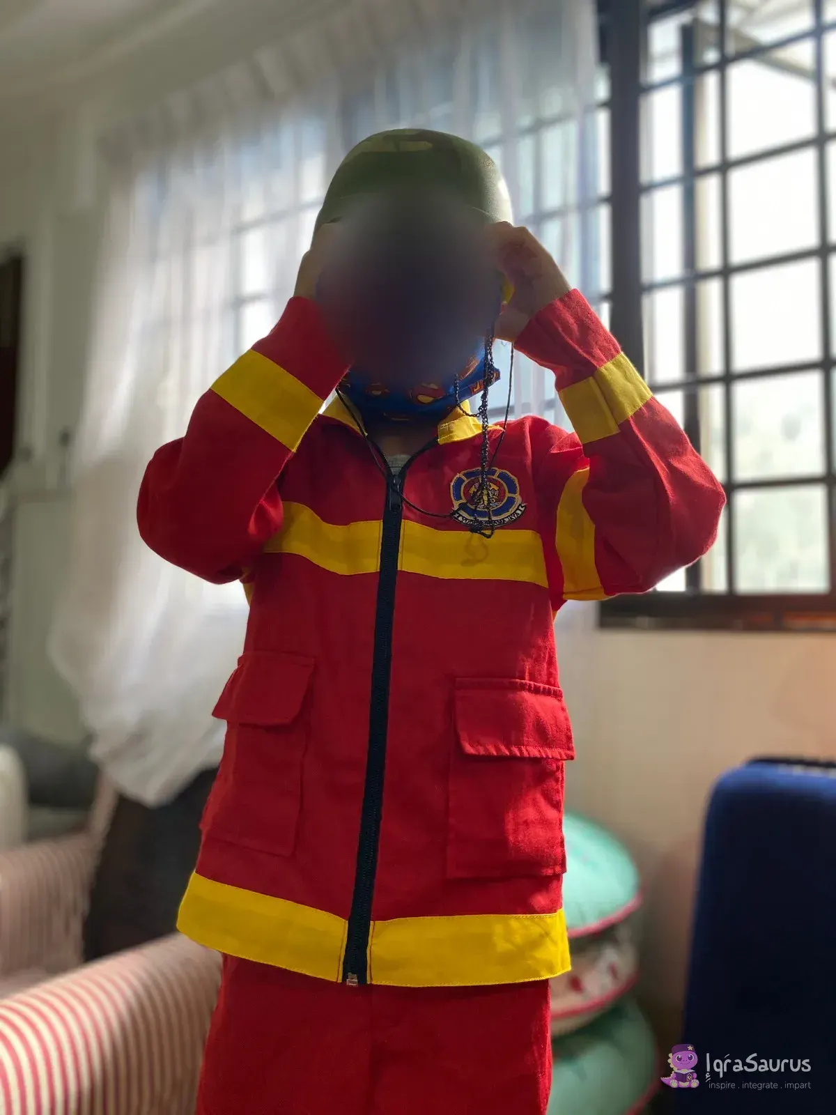 A child in a red and yellow firefighter's suit and helmet