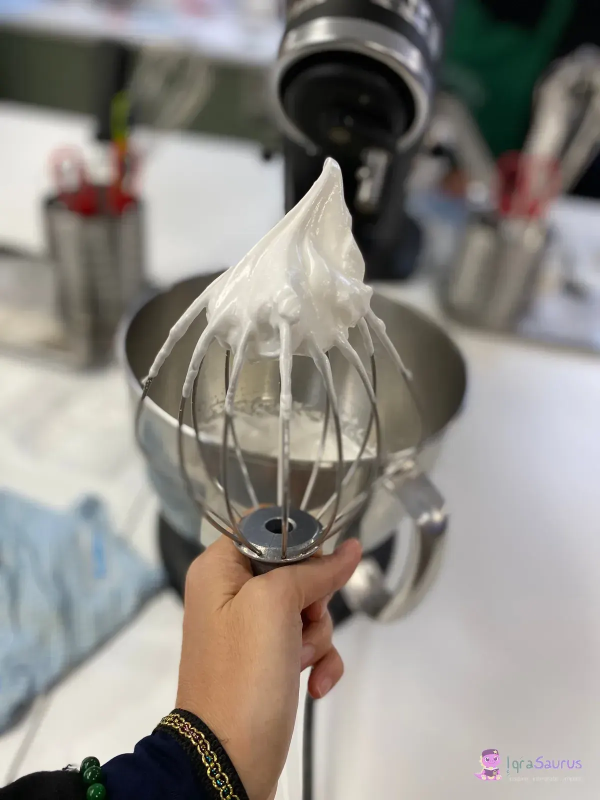 Whipped cream standing on a mixer whisk