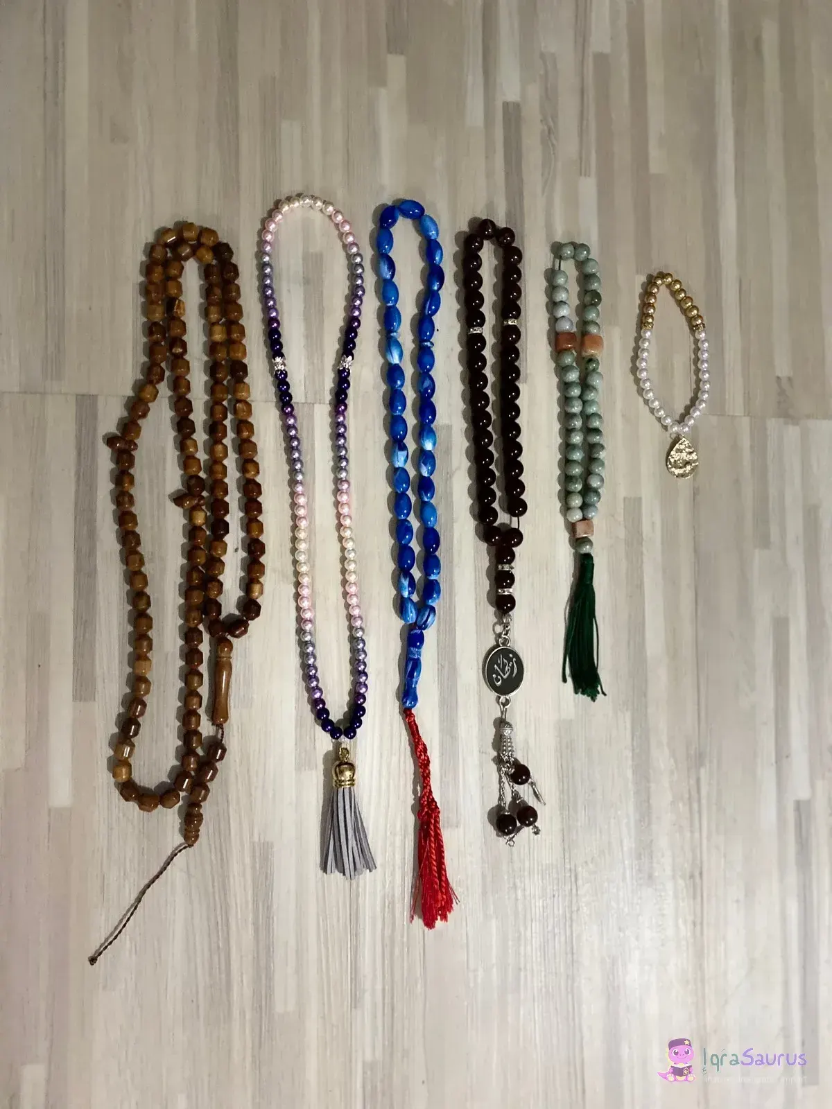 Several strings of prayer beads laid out side by side