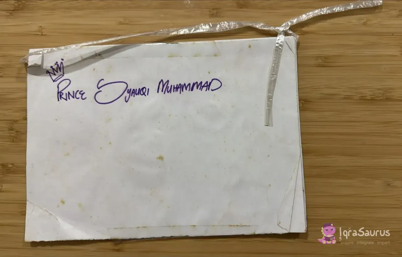 A worn home-made booklet tied with a plastic strap, with a crown and the owner's name written in purple pen.