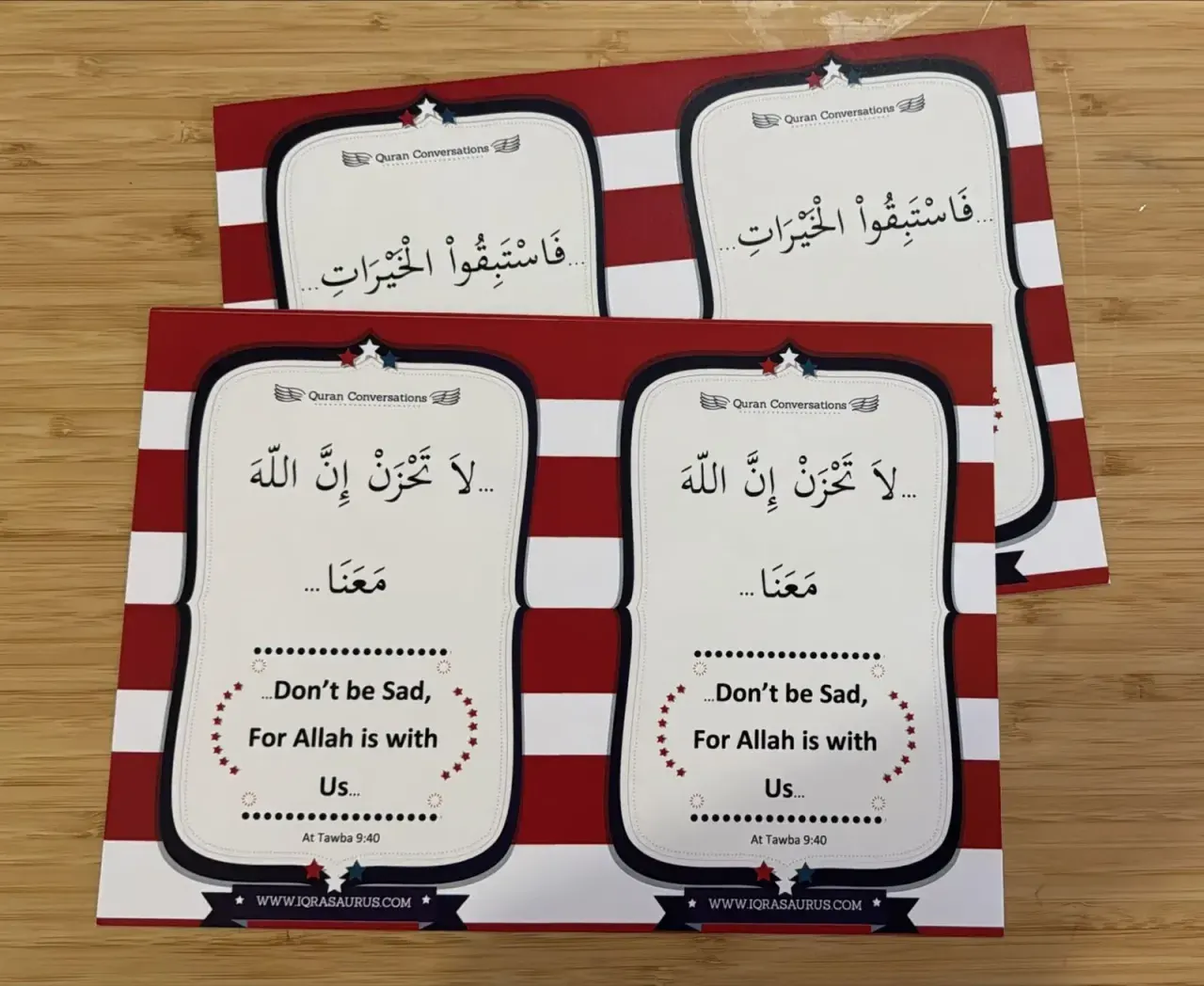 Two printed sheets of Quran Conversations cards with Arabic phrases inside red and white striped borders