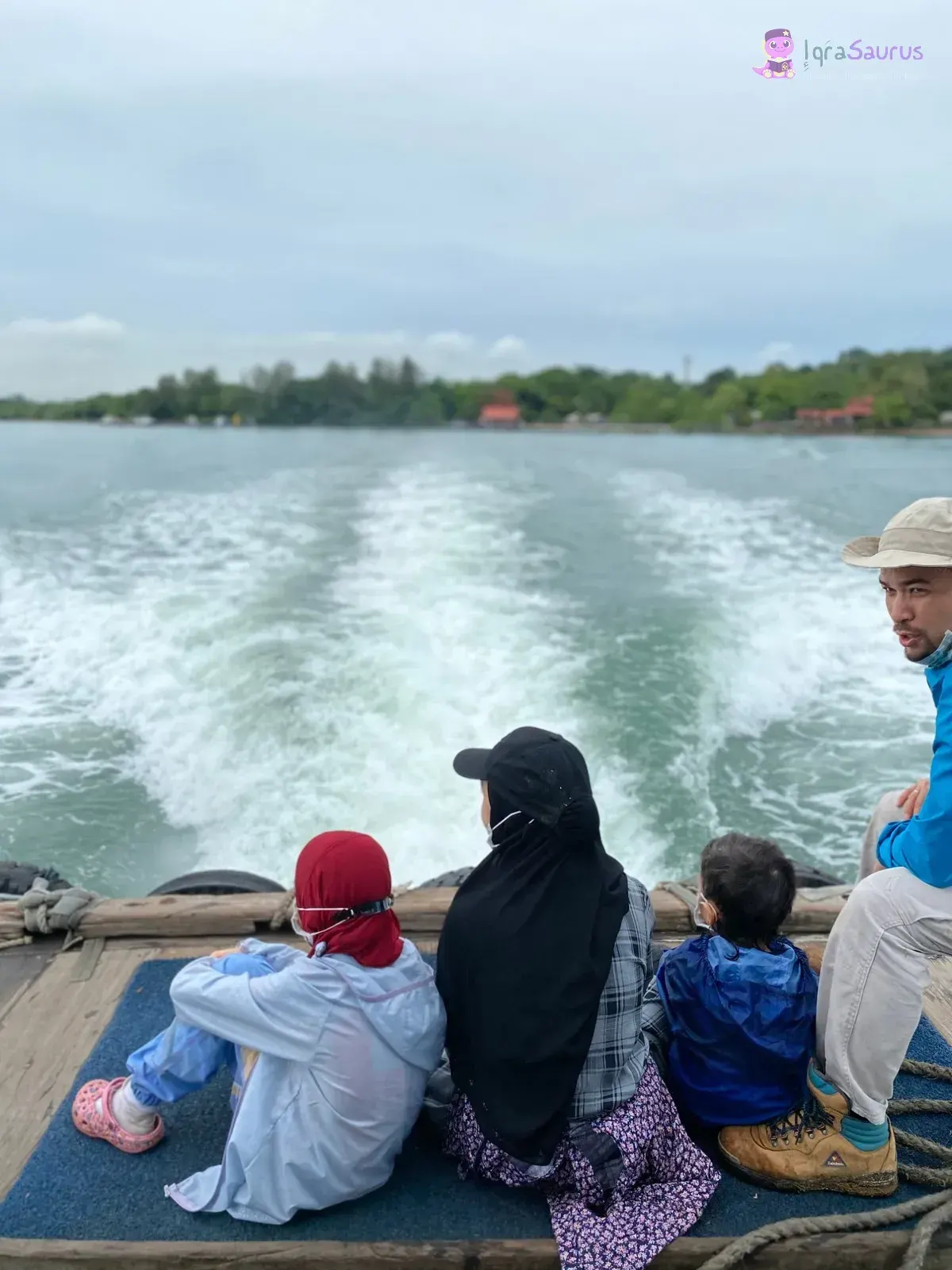 Daddy and three of our children at the back of a bumboat on the Pulau Ubin trip, with the wake behind them